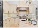 Chef's kitchen boasts custom cabinetry, mosaic backsplash, and high-end stainless-steel appliances at 6143 Cartmel Ln, Windermere, FL 34786