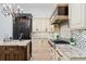 Luxury kitchen featuring dark appliances, an island, and high-end finishes at 6143 Cartmel Ln, Windermere, FL 34786