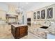 Gourmet kitchen featuring marble countertops, an island, and stainless steel appliances at 6143 Cartmel Ln, Windermere, FL 34786