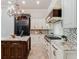 Gourmet kitchen featuring custom cabinets, granite countertops, and stainless steel appliances at 6143 Cartmel Ln, Windermere, FL 34786