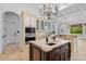 Gourmet kitchen features custom cabinets, island with sink, granite counters, and pendant lighting at 6143 Cartmel Ln, Windermere, FL 34786