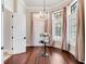 Elegant living room featuring hardwood floors, a chandelier, and natural light from large windows with drapes at 6143 Cartmel Ln, Windermere, FL 34786