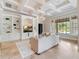 Bright living room boasts coffered ceilings, custom built-ins, and large windows for abundant natural light at 6143 Cartmel Ln, Windermere, FL 34786