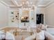 Elegant living room featuring a chandelier, custom shelving, and a comfortable seating arrangement at 6143 Cartmel Ln, Windermere, FL 34786