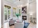Bright living room with fireplace, chandelier, French doors, and tile floors at 6143 Cartmel Ln, Windermere, FL 34786