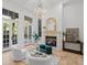 Bright living room boasts a fireplace, large windows, and plush seating, perfect for relaxation at 6143 Cartmel Ln, Windermere, FL 34786