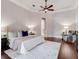 Bright main bedroom featuring tray ceilings, hardwood floors, and an archway leading to another room at 6143 Cartmel Ln, Windermere, FL 34786