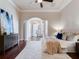 Bright main bedroom featuring tray ceilings, hardwood floors, and a doorway leading to another room at 6143 Cartmel Ln, Windermere, FL 34786