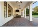 Outdoor living area with a built in grill, mini fridge, covered patio, and brick pavers at 6143 Cartmel Ln, Windermere, FL 34786