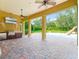 Beautiful covered patio boasts a built-in grill, TV, ceiling fans, and a stunning pool with a slide for ultimate outdoor living at 6143 Cartmel Ln, Windermere, FL 34786