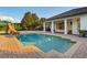 Beautiful backyard pool area featuring a water slide, a large covered patio, and beautiful landscaping at 6143 Cartmel Ln, Windermere, FL 34786