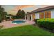 Beautiful backyard pool area featuring a water slide, a large covered patio, and beautiful landscaping at 6143 Cartmel Ln, Windermere, FL 34786