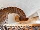 Unique spiral staircase with detailed ironwork and elegant wood steps, creating a striking focal point at 6143 Cartmel Ln, Windermere, FL 34786