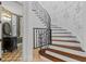 Ornate staircase with decorative wall paneling and detailed iron railing leads to the upper level at 6143 Cartmel Ln, Windermere, FL 34786