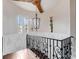 Elegant staircase featuring decorative iron railings and a chandelier, adding a touch of sophistication to the home at 6143 Cartmel Ln, Windermere, FL 34786