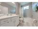 Clean bathroom featuring a large mirror, vanity, and tiled shower and tub at 6667 Alder Rd, Harmony, FL 34773