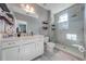 Modern bathroom featuring a glass shower, vanity with marble countertop, and ample storage shelves at 6667 Alder Rd, Harmony, FL 34773