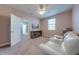 Cozy bedroom with plush carpet, neutral walls, ceiling fan, and large window with blinds for ample natural light at 6667 Alder Rd, Harmony, FL 34773