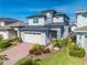 Beautiful two-story home with a well-manicured lawn and a two car garage at 6667 Alder Rd, Harmony, FL 34773