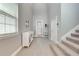 Bright foyer features high ceilings, tile flooring, and a staircase to the upper level at 6667 Alder Rd, Harmony, FL 34773