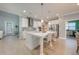 Spacious kitchen with a large island, pendant lighting, stainless steel appliances, and gray backsplash at 6667 Alder Rd, Harmony, FL 34773