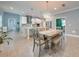 Open-concept kitchen and dining area with modern lighting and tile flooring at 6667 Alder Rd, Harmony, FL 34773