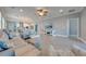 Bright and spacious living room area with tile floors, ceiling fan, recessed lights, and an open floor plan at 6667 Alder Rd, Harmony, FL 34773