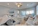 Comfortable living room featuring neutral tones, crown molding, ceiling fan, and access to the patio at 6667 Alder Rd, Harmony, FL 34773