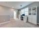 Bright home office with a built in desk and storage cabinets, with neutral walls and carpet at 6667 Alder Rd, Harmony, FL 34773