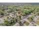 Overhead view of a neighborhood with lush greenery, featuring tidy properties and a peaceful residential environment at 825 Second St, Orange City, FL 32763