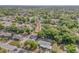 Aerial shot highlighting a residential area with green spaces and neat homes, presenting a tranquil suburban ambiance at 825 Second St, Orange City, FL 32763