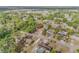 An aerial view of a neighborhood with mature trees and well-maintained homes, showcasing a serene community setting at 825 Second St, Orange City, FL 32763