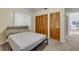 Bedroom featuring closet with wooden doors and neutral decor at 825 Second St, Orange City, FL 32763