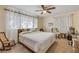 Comfortable bedroom with carpeted floors, ceiling fan, and white curtains at 825 Second St, Orange City, FL 32763