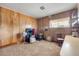Bonus room with wood paneling, carpeted floors, and natural light at 825 Second St, Orange City, FL 32763
