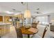 A combined dining and living area includes a ceiling fan and transition to kitchen area at 825 Second St, Orange City, FL 32763