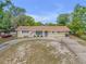 Charming single-story home with a circular driveway and manicured landscaping at 825 Second St, Orange City, FL 32763