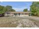 Charming single-story home with a covered parking area and well-maintained front lawn at 825 Second St, Orange City, FL 32763
