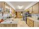 Bright kitchen with light wood cabinets, stainless steel appliances, and ample counter space at 825 Second St, Orange City, FL 32763