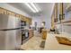 A well-designed kitchen featuring modern appliances and warm cabinets, open to the dining area at 825 Second St, Orange City, FL 32763