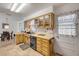 Well-lit kitchen showcasing wood cabinets, light countertops, and easy access to the dining area at 825 Second St, Orange City, FL 32763
