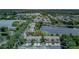 Aerial view of townhomes nestled near a picturesque lake, providing tranquil community setting at 8419 Chamberlain Pl, Oviedo, FL 32765