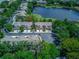 Bird's eye view of community with a nearby lake, complemented by lush greenery and scenic landscape at 8419 Chamberlain Pl, Oviedo, FL 32765