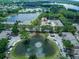 Aerial image of a neighborhood near a large pond, close to community pool and other townhomes at 8419 Chamberlain Pl, Oviedo, FL 32765