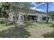 Wide backyard with covered patio, providing ample space and fresh air for Gathering gatherings and play at 8419 Chamberlain Pl, Oviedo, FL 32765