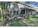 Spacious patio with screened-in porch and green backyard provides a peaceful outdoor retreat and relaxation at 8419 Chamberlain Pl, Oviedo, FL 32765
