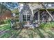 Lovely patio with screened-in porch and backyard garden offers outdoor living for relaxation and enjoyment at 8419 Chamberlain Pl, Oviedo, FL 32765