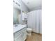This bathroom features a white vanity, a toilet, and a shower/tub with curtain at 8419 Chamberlain Pl, Oviedo, FL 32765