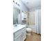 Bathroom featuring white vanity, toilet, and shower with curtain, offering a clean design at 8419 Chamberlain Pl, Oviedo, FL 32765