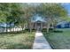 Community clubhouse with a manicured lawn and mature trees at 8419 Chamberlain Pl, Oviedo, FL 32765